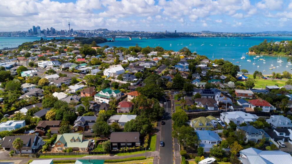 View of coastal suburbs in Auckland with homes, harbours, boats and the Auckland city skyline