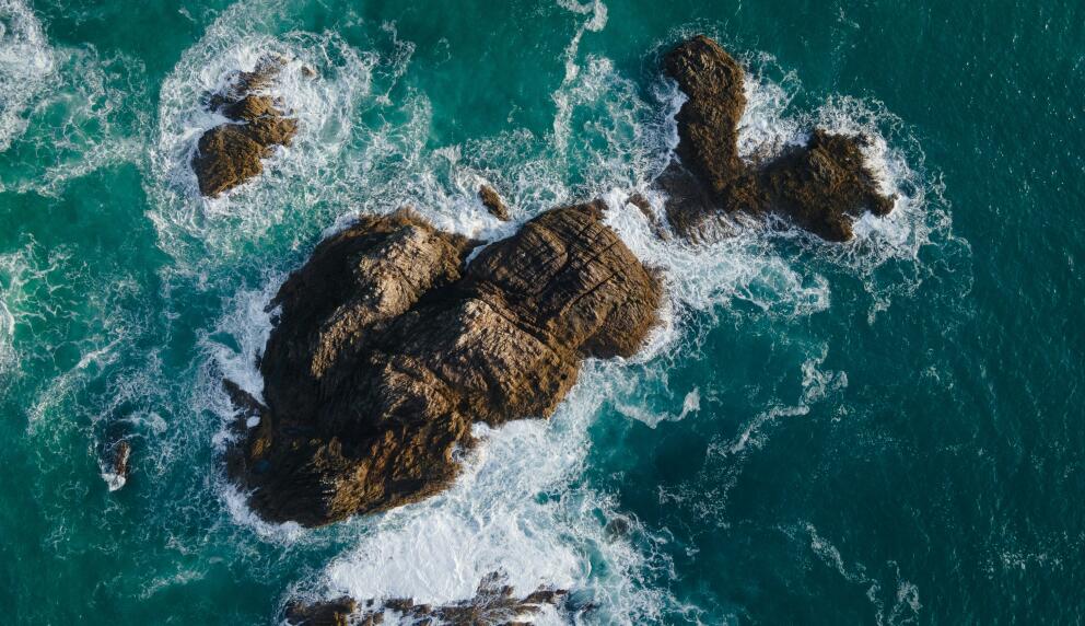 Aerial view of rocks and waves off coast of New Zealand